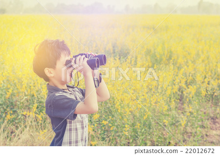 boy in field scanning the surrounding by binocular boy in field scanning the surrounding by binocular 22012672