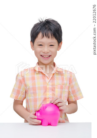 Happy Asian boy inserting coin into piggy bank 22012676
