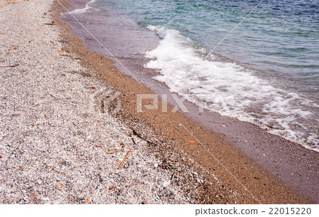 Beach of coarse sand and stones with wave. 22015220