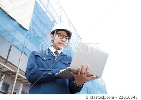 A man checking with a notebook PC at the construction site A man checking with a notebook PC at the construction site 22016545