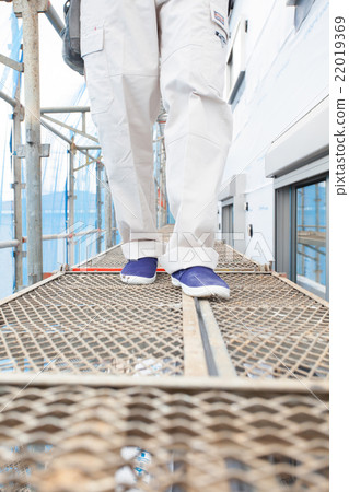 Construction worker Construction worker walking on the scaffold 22019369