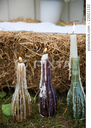 Burning candle in the vintage black bottle. Burning candle in the vintage black bottle. 22021132