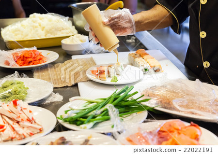 Preparing of sushi rolls with salmon 22022191