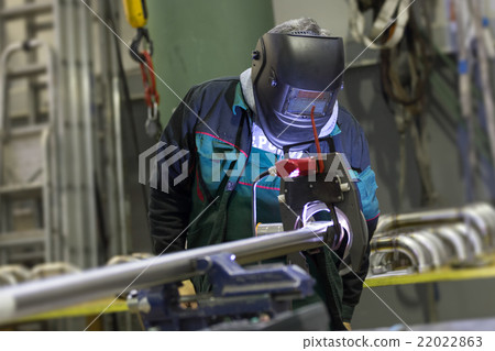 Industrial worker setting orbital welding machine. 22022863