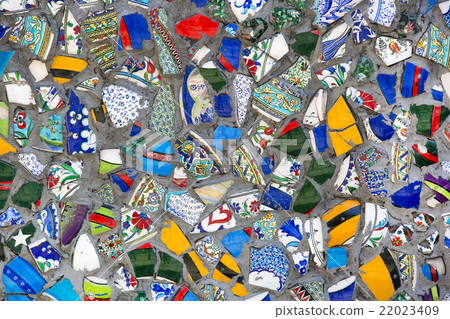 wall with broken ceramic plates colored fragments 22023409