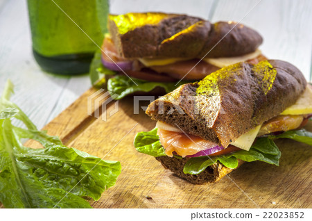 Two sandwiches with salmon, vegetables and bread Two sandwiches with salmon, vegetables and bread 22023852