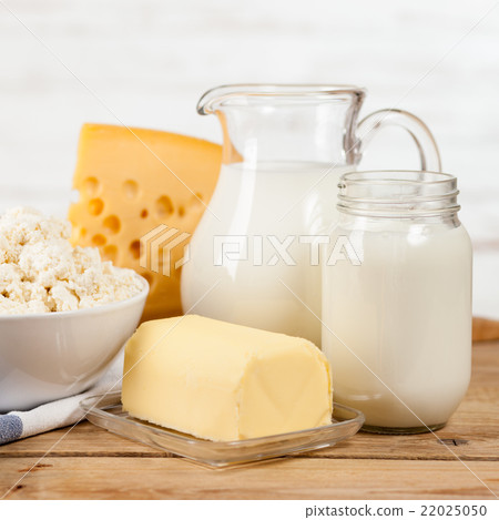 Milk jar on wooden table Milk jar on wooden table 22025050