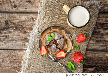 Chocolate fondant  with strawberry on the table 22025599