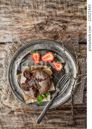 Chocolate fondant  with strawberry on the  table 22025945