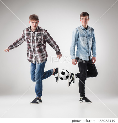 The two boys with balls on gray background The two boys with balls on gray background 22028349