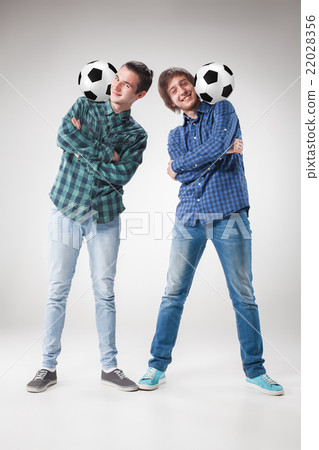 The two boys with balls on gray background 22028356