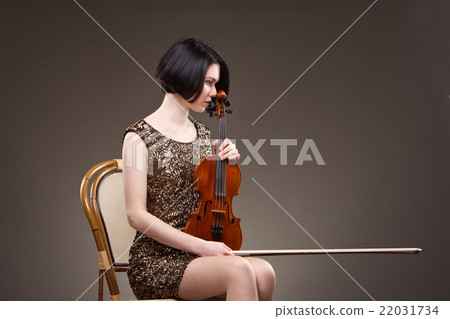 Girl playing violin in gold dress 22031734