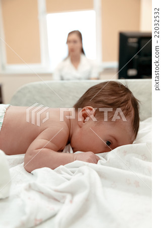 Newborn baby lying on the table in doctor's office Newborn baby lying on the table in doctor's office 22032532
