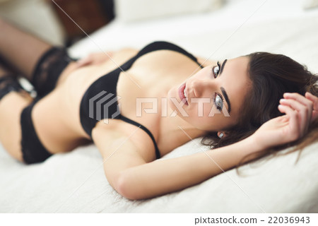 Sexy young woman in lingerie posing on the bed Sexy young woman in lingerie posing on the bed 22036943