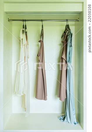 row of dress hanging on coat hanger in wardrobe row of dress hanging on coat hanger in wardrobe 22038108