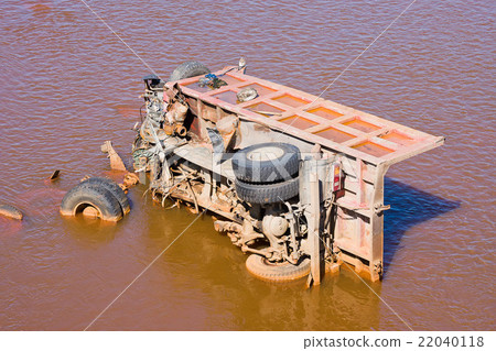 the broken truck lies in dirty water the broken truck lies in dirty water 22040118