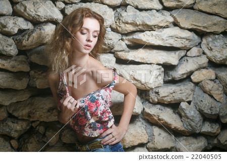 Young sexy model posing near old weathered wall Young sexy model posing near old weathered wall 22040505