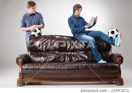 The two guys with balls on gray background The two guys with balls on gray background 22041673