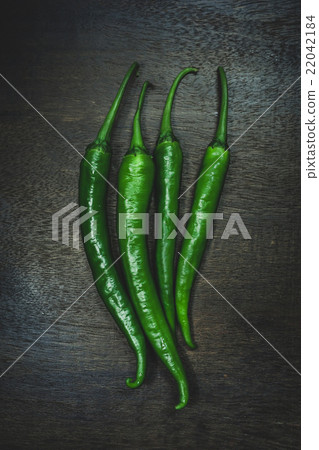 Close up hot peppers spices on black wooden table Close up hot peppers spices on black wooden table 22042184