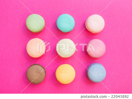 Sweet colorful French macaroon biscuits on bright 22043892
