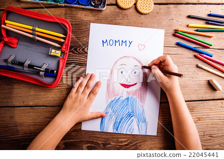 Unrecognizable girl drawing picture of her mother 22045441