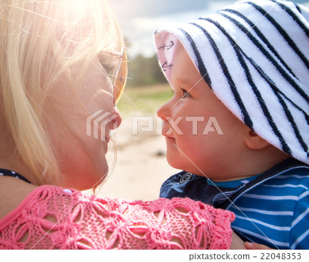 woman and baby at the beach near sea woman and baby at the beach near sea 22048353