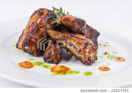 hot smoked barbecue ribs on white plate hot smoked barbecue ribs on white plate 22053761