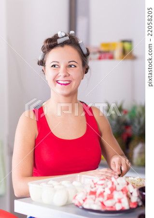 Young pretty woman housewife cooking curlers hair 22058205