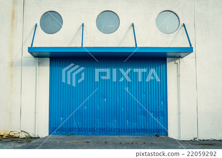 Blue gate on a grungy wall Blue gate on a grungy wall 22059292