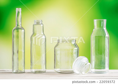 Empty glass bottles on a table 22059372