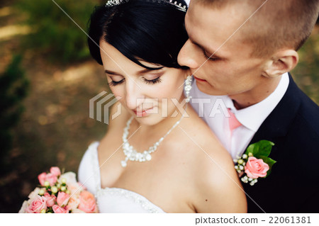 Bride and handsome groom lovely hugging outdoors 22061381