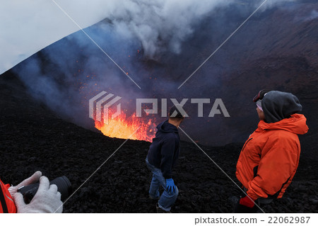 Tourists watching eruption of volcano Tourists watching eruption of volcano 22062987
