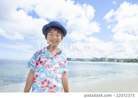 A boy standing on the beach 22072373