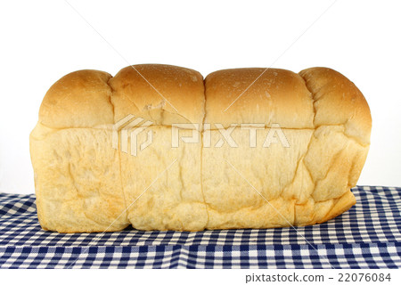 loaf of bread on tablecloth 22076084