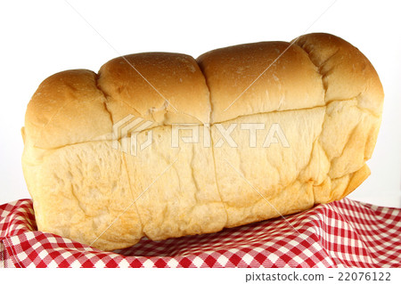 图库照片: loaf of bread on tablecloth