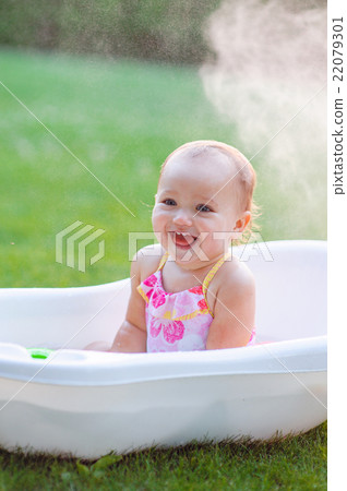 little girl bathes in a bath 22079301