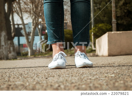 female legs closeup with casual shoes outdoor 22079821