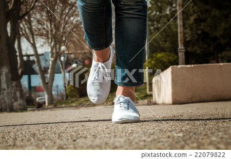 female legs closeup with casual shoes outdoor female legs closeup with casual shoes outdoor 22079822