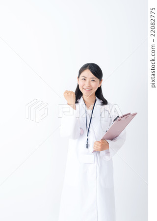 A middle woman wearing a white suit to play a guts pose A middle woman wearing a white suit to play a guts pose 22082775