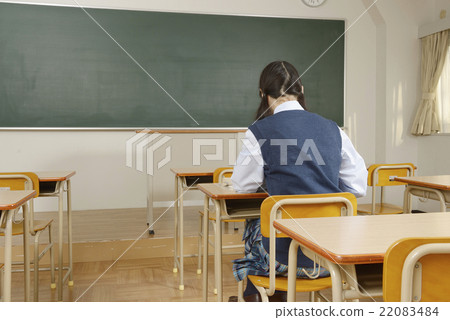 A girl's high school student who studies seriously behind her A girl's high school student who studies seriously behind her 22083484
