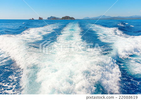 Waves on blue sea behind the boat 22088619