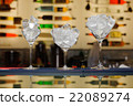 three glasses with ice on the bar 22089274