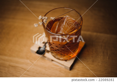 Whiskey drink with  ice  on  wood in bar 22089281
