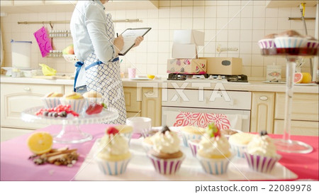 Woman counting boxes in the kitchen 22089978