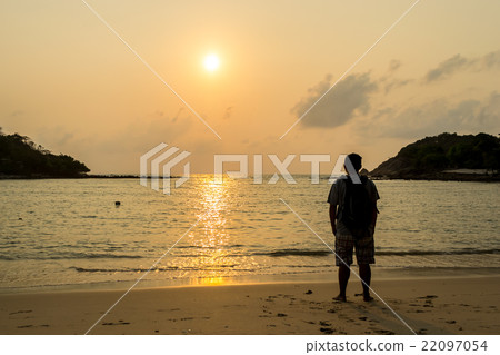 Young tourists stand and watch the sunrise Young tourists stand and watch the sunrise 22097054