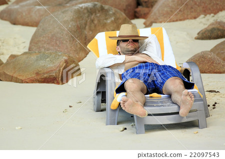 Tourist resting on a lounger. Sandy beach at the 22097543