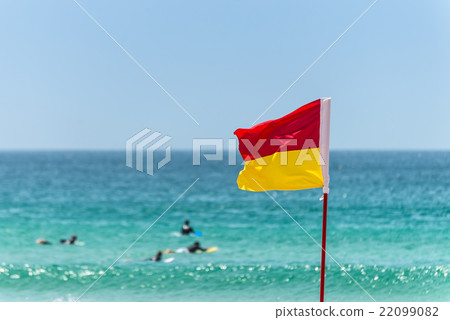 Red And Yellow Warning Sign Flag at the Beach 22099082