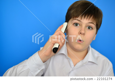 Surprised teenage boy talking by radiotelephony Surprised teenage boy talking by radiotelephony 22101274