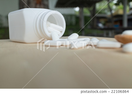 many white medicine on wood plate 22106864