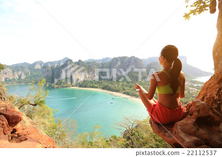 young healthy woman practice yoga on mountain peak rock 22112537
